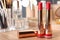 Open lipsticks in gold tubes on dressing table