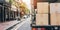 Open lorry car trunk full of moving cardboard boxes and furniture outdoors at city street.