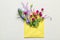 Open mail envelope with flowers on light textured background