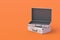 Open metal suitcases for lot of money or documents on orange background