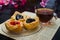 Open mini pies with berries jams and cup of tea