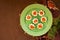 Open mini sandwiches on white bread with red caviar on a green plate on a brown concrete background in Christmas and New Year