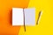 Open mockup notepad on geometric orange and yellow background