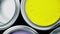 Open multicolor paint cans on grey background, top view