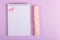 Open notebook with a blank page, marshmallow stick and little valentine on a background of polka dot