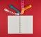 open notebook in line and multicolored serpentine on a red background