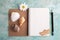 Open notebook, pencil, sea shells, wooden boat