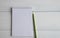 Open notebook in a ruler, a blank page and a pencil lie next to a white wooden table. Place for text. Copy space