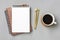 Open notepad, cup of coffee, golden pen moose on gray background