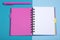 Open notepad and a pink fountain pen