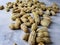 Open peanuts shot macro in studio, white wall texture background