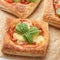 Open pies puff pastry with tomato, mozzarella, onion and Basil