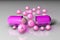 Open pink capsule with essential vitamin pills. Vitamin and mineral complex. Healthy life concept. Medical background