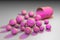 Open pink capsule with pink omega-6 pills. Vegetable oil capsules. Polyunsaturated fatty acids. Vitamin and mineral