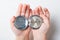 Open pocket watch in children`s palms on a light background