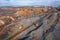 Open Quarry with heavy duty machinery. Construction industry aerial view.