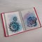 open red diary on study table with watercolor paint hand drawn mandala rose print