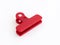 Open red plastic medium size clothespin for plastic bags isolated on a white background