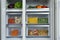 Open refrigerator with different vegetables, closeup