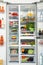 Open refrigerator full of fresh products