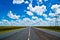 Open road beneath a brilliant blue African sky