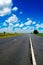 Open road beneath a brilliant blue African sky