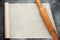 Open roll of baking parchment paper with rolling pin for menu or
