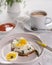 Open sandwich with cottage cheese and boiled eggs on a light plate. Above view