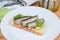 Open sandwich with preserved smoked sprats close-up