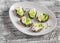 Open sandwiches with cream cheese, quail eggs and celery. Delicious healthy Easter snack