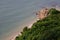 Open sea with waves and rocks and hills and trees