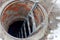 Open sewer hatch. worker carries out work on the maintenance of communications