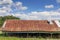 Open side pole barn with hay bales, rusted tin roof, creative copy space, rural farm pasture