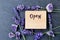 Open sign for alternative therapy business - word burnt in wood with purple lavender flowers and amethyst clusters