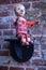 Open sign; German boy figurine on a brick wall