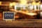 Open signs text on wooden board with blurry image of restaurant or coffee shop.