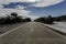 Open snow capped road with blue sky