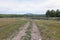 open space. country road going into distance into forest, into mountains. Nearby abandoned corral