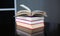 Open stack hardback books on wooden table. Education background