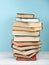 Open stacking book, hardback colorful books on wooden table and blue background. Back to school. Copy space for text