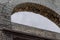 Open stone and brick archway with gray clouds behind, creative copy space