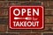 Open for Takeout message on hanging red sign for restaurants