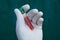 Open test-tube with blood in hand in glove on a green background