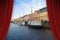 Open theater red curtains against Nyhavn city during the Christmas holidays - Europe - Denmark - Copenhagen - concept image