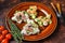 Open toast sandwich with salmon and herring, cream cheese and salad. dark background. Top view