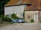 Open topped Sports car outside farm house