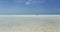 open view of Cuban Cayo Coco island wild beach with turquoise, tranquil ocean and person going far toward horizon line