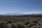 Open view on mountains and meadows with blue sky