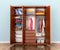 Open wardrobe compartment with clothes