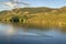 Open water swimmer with swim buoy on a mountain lake